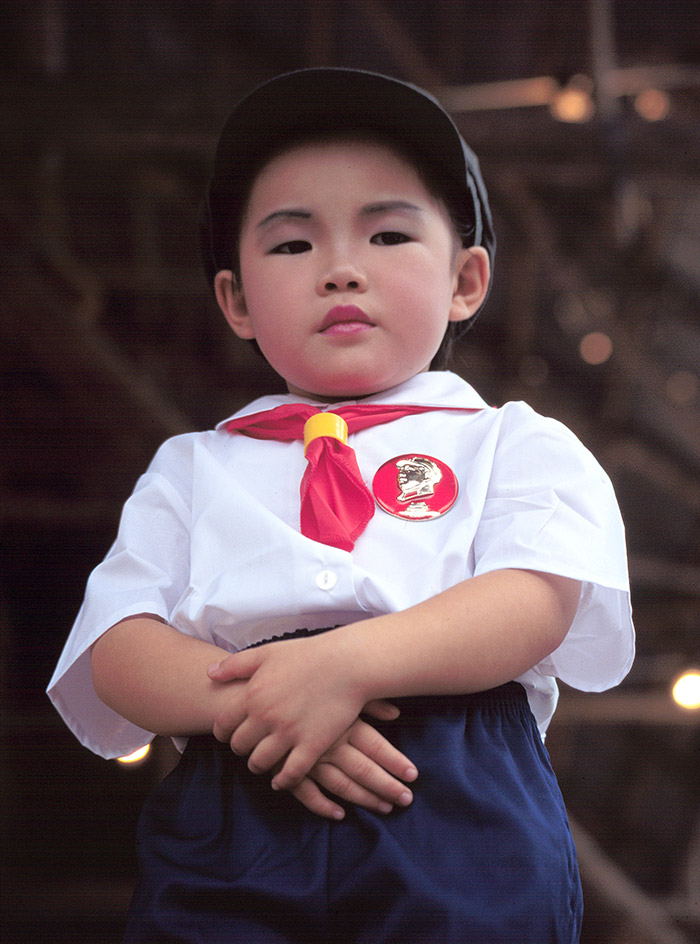 A young boy dressed as Chairman Mao.