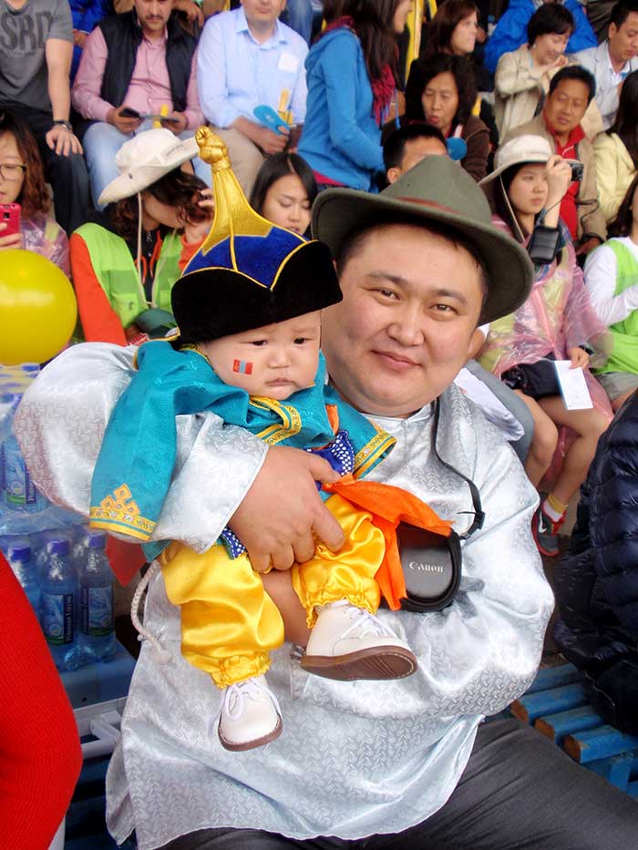 An infant dressed for the Naadam