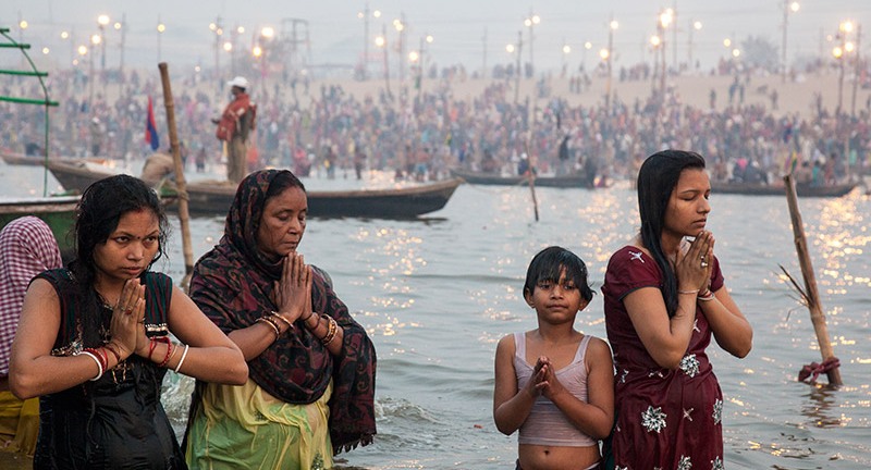 Worshippers celebrating Kumbh Mela with a dip in the Ganges