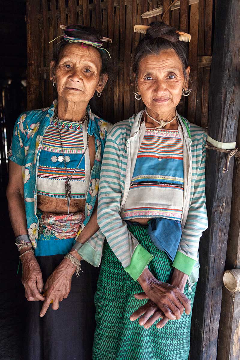 Two Khoui minority women, with distinctive combs in their hair.