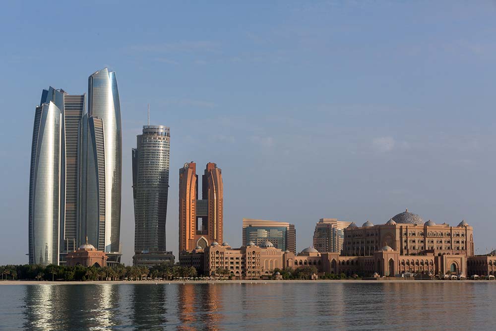 Emirates Palace Hotel and the Etihad Towers standing prominently on the Abu Dhabi skyline.