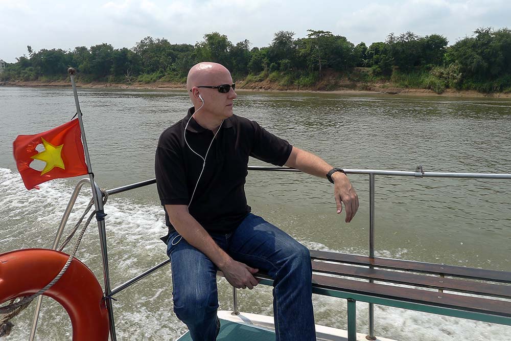 On the deck of the Blue Cruiser, watching the Cambodian countryside pass by.