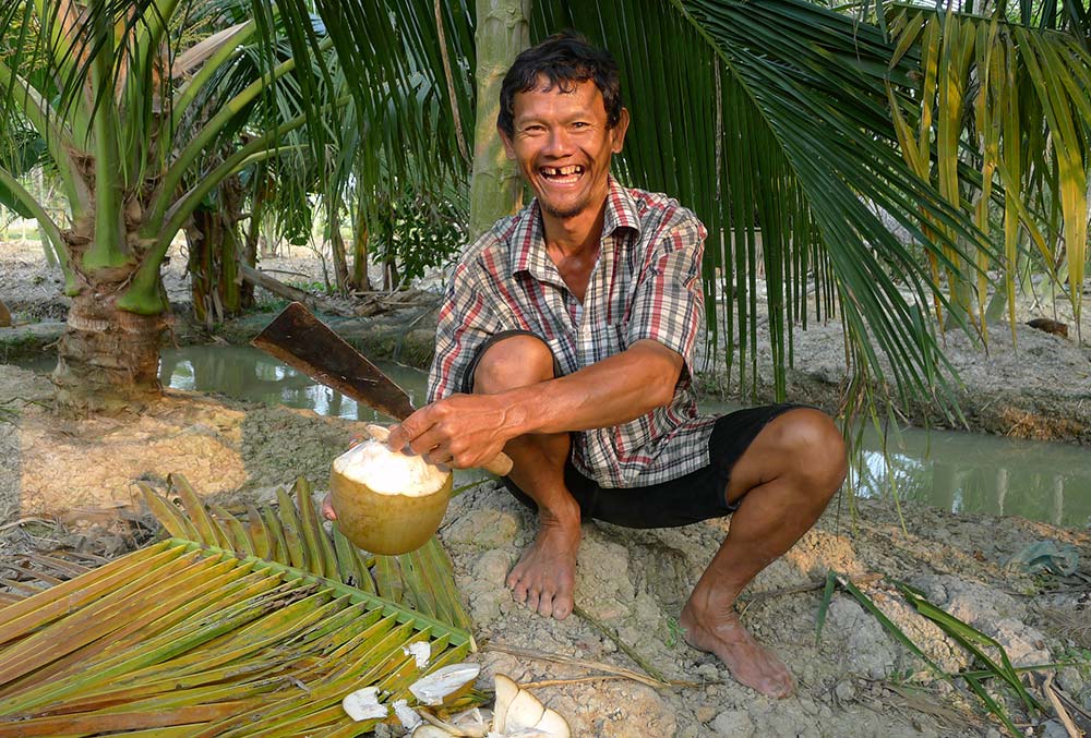 This coconut farmer was probably one of the happiest farmers I 've ever seen!