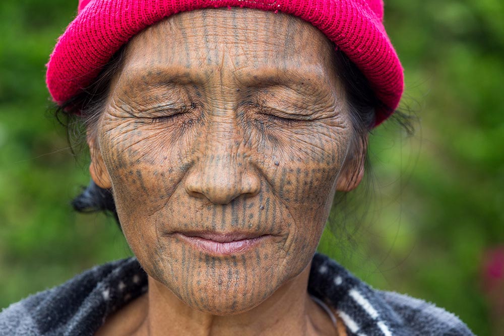 A Nga-Ya Chin woman shows us the tattoos on her eyelids, which she said hurt the most.